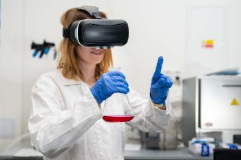 Scientist wearing VR goggles, lab coat, holding flask for playing in Metaverse digital cyberspace with virtual reality. NFT technology of future entertainment.